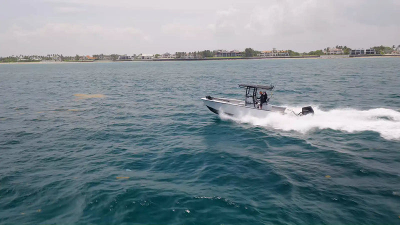 The LTB 25 speeding along with a long white wake and a low coastline in the distance