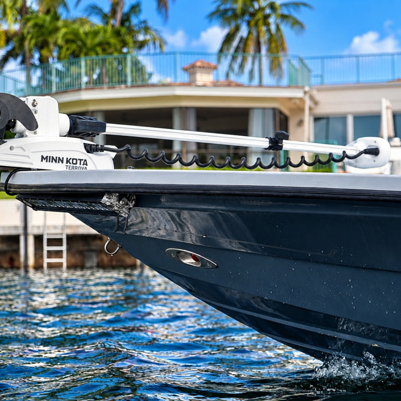 The bow of the dark-blue hull up close, with a white Minn Kota Terrova trolling motor mounted on top