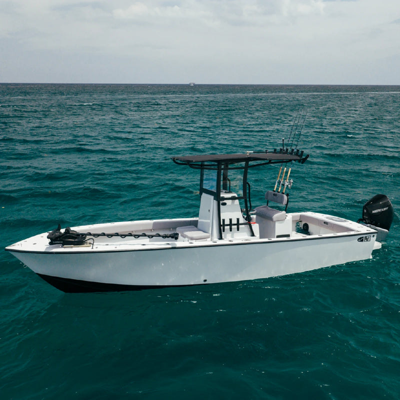 A side view of the white LTB 25 on green water, showing the T-top, center console, open deck and black outboard